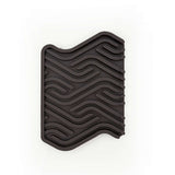 Black rubber mat with wavy pattern on a white background